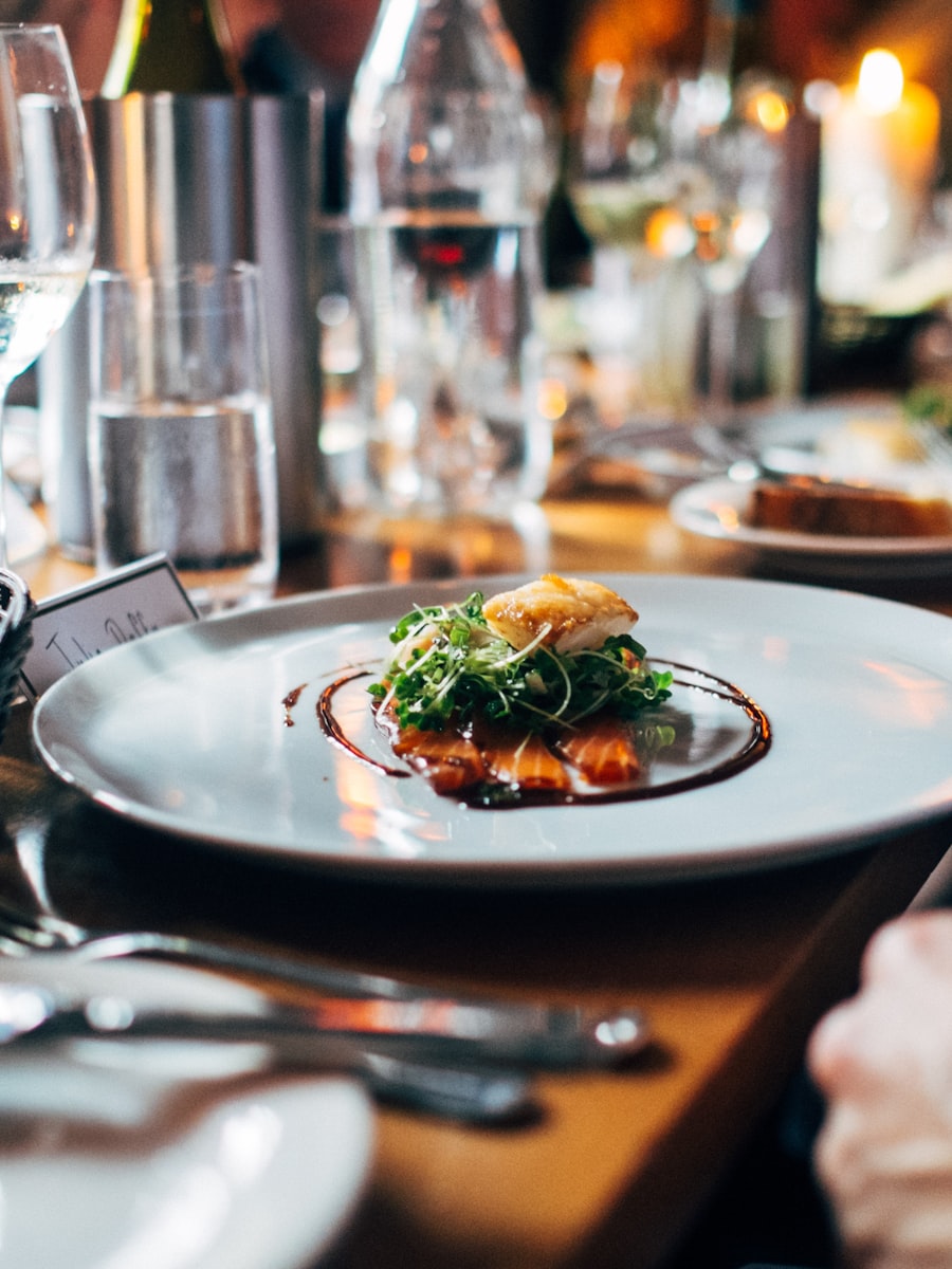 A plated dinner being served at a candlelit table