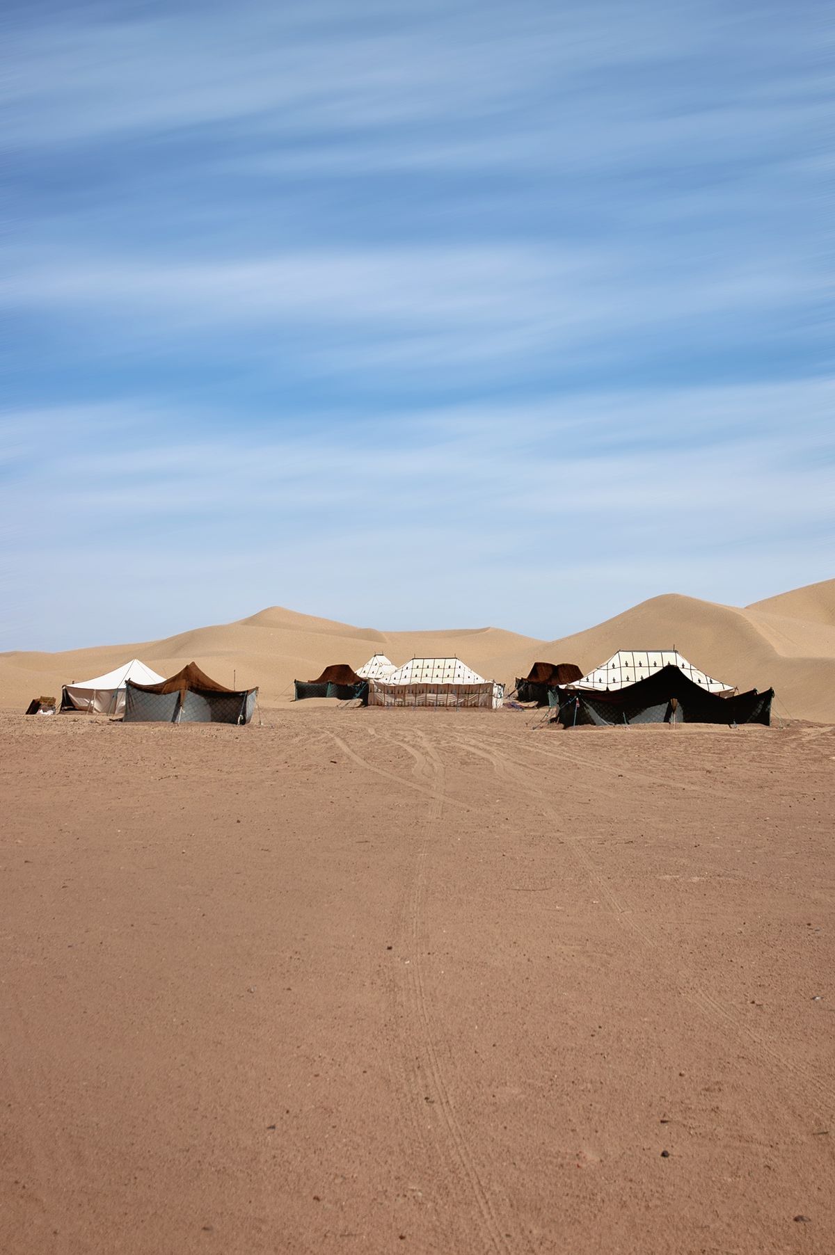 The camp’s tents lined up on the sand