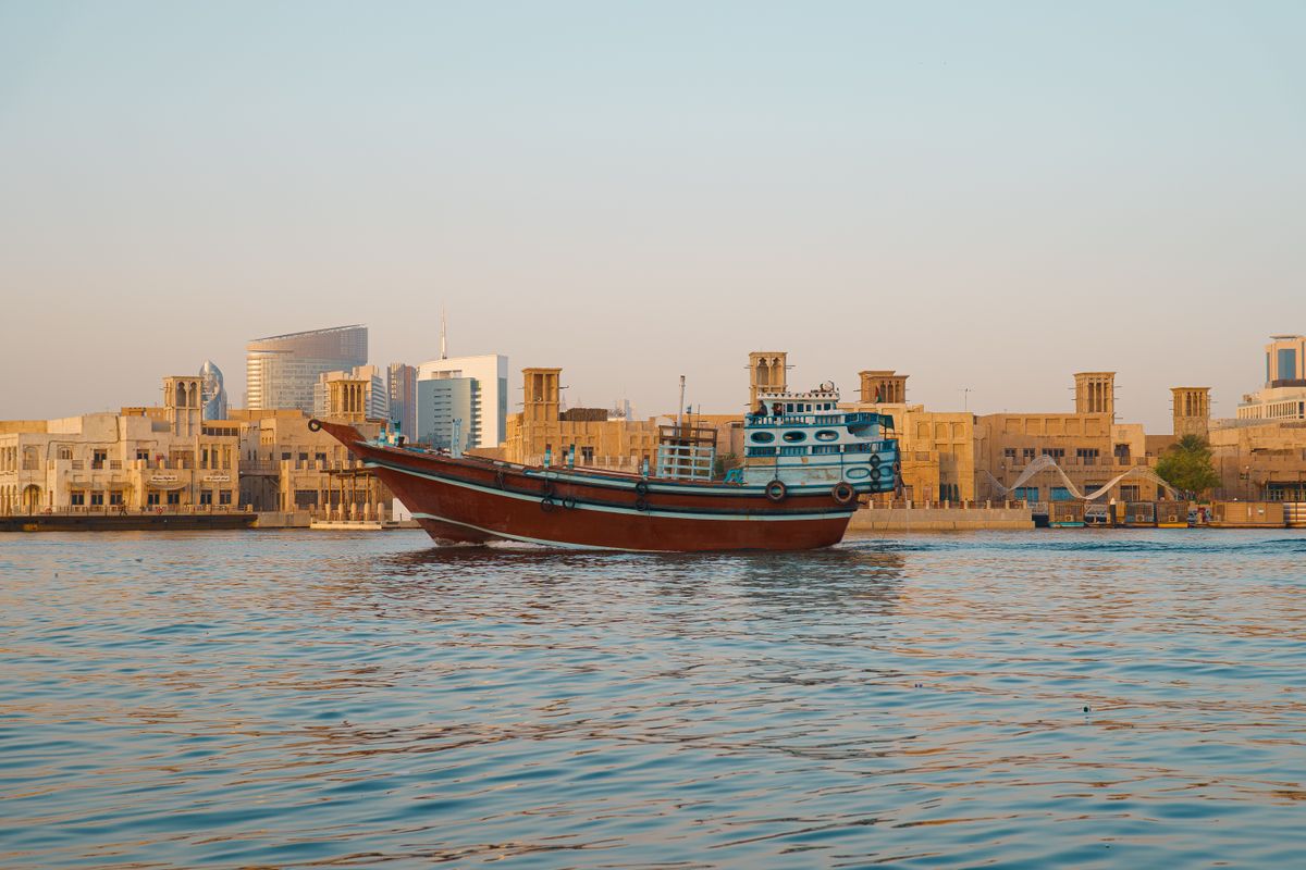 The dhow easing past old Dubai’s waterfront