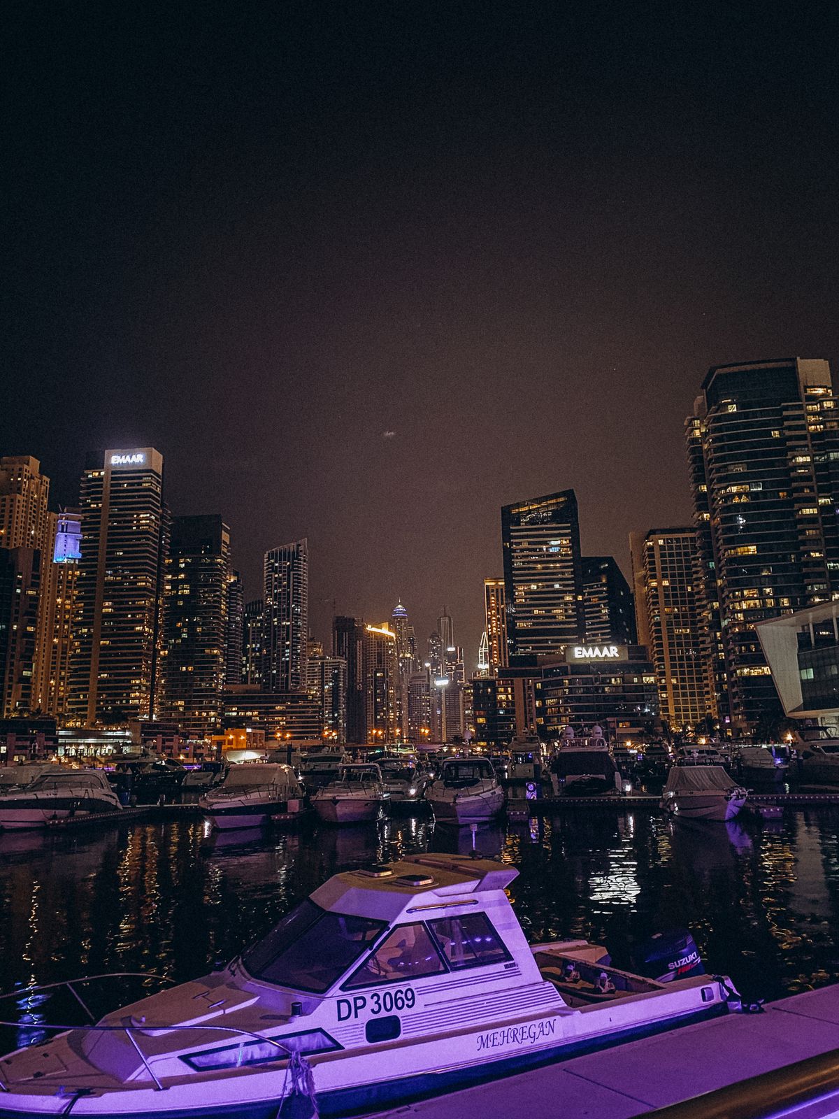 Marina towers reflected in the water from the dhow deck