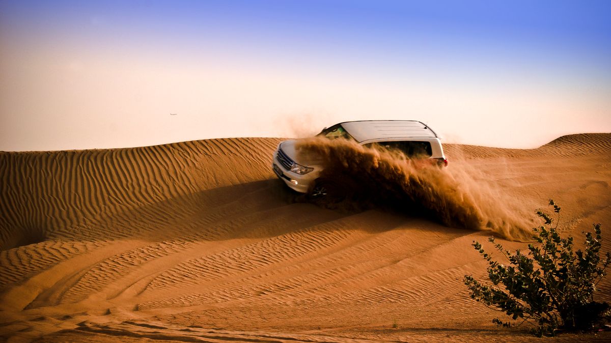 A guest at the wheel crossing soft evening sand