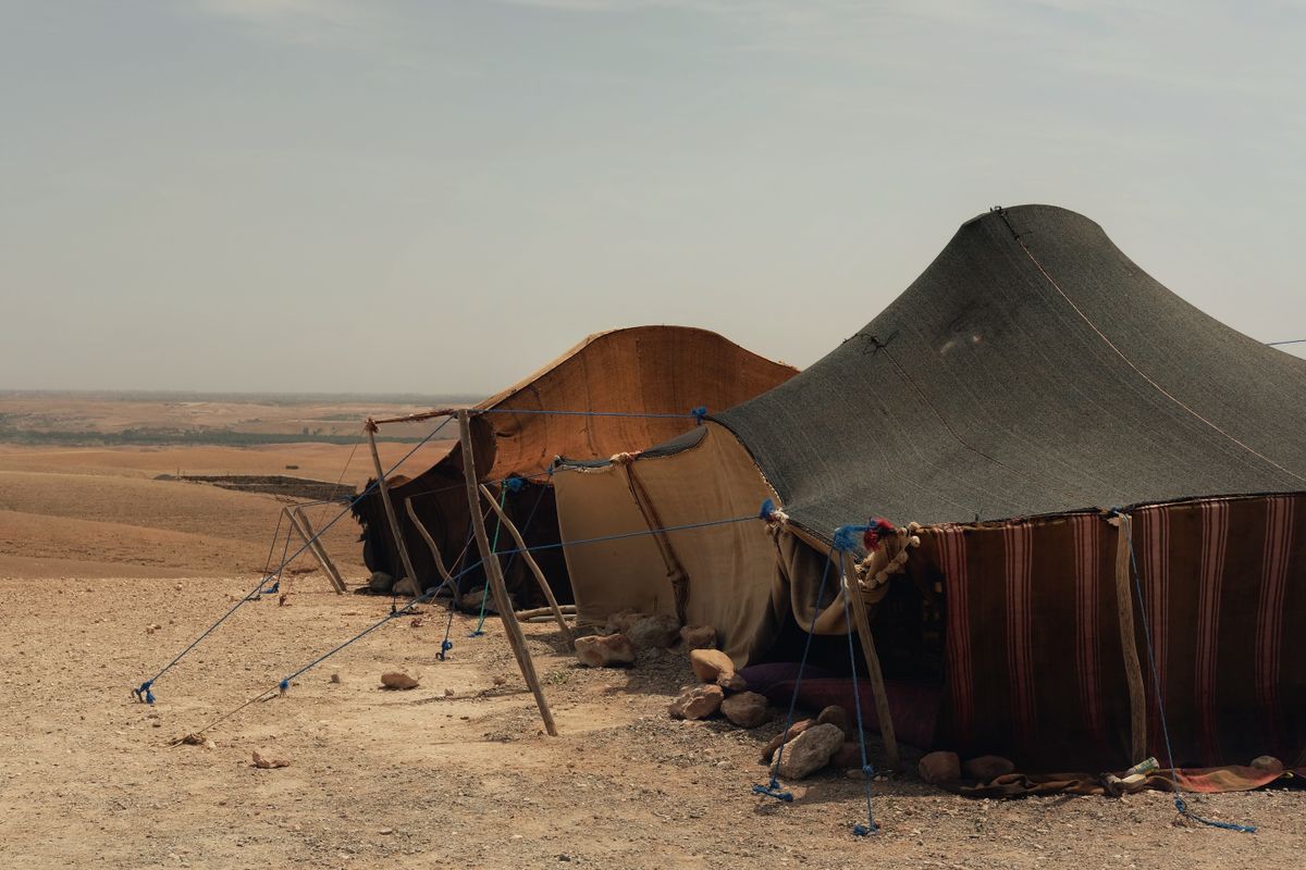 Traditional tents waiting under a clear desert sky