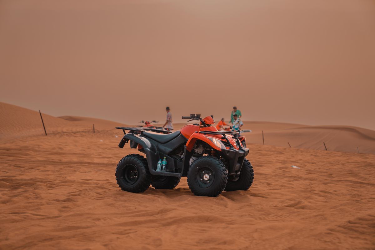 A quad bike parked on untouched desert sand