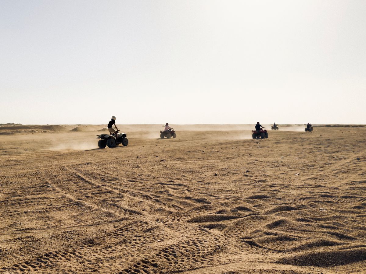Riders crossing the open plain before the dune belt