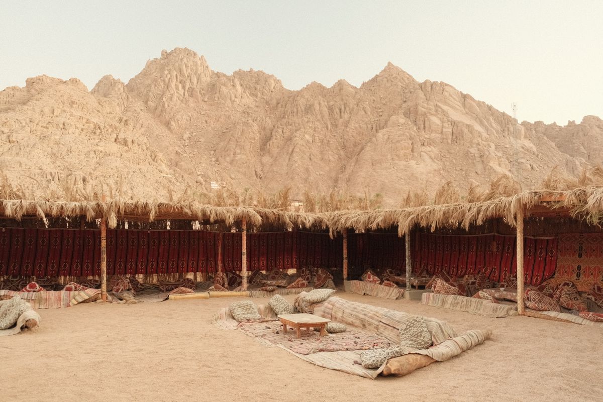 A traditional tent glowing under a warm evening sky