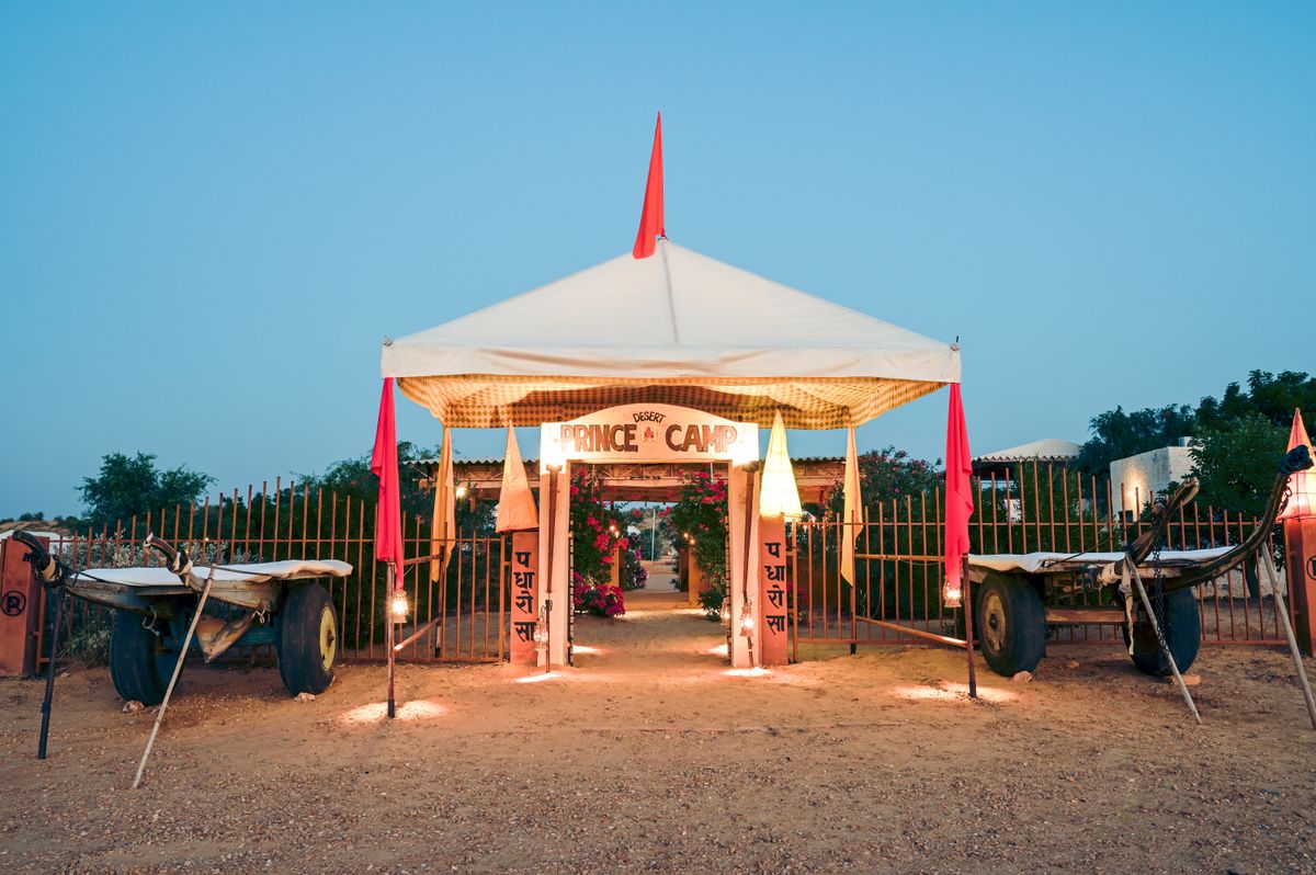 The camp entrance glowing at twilight