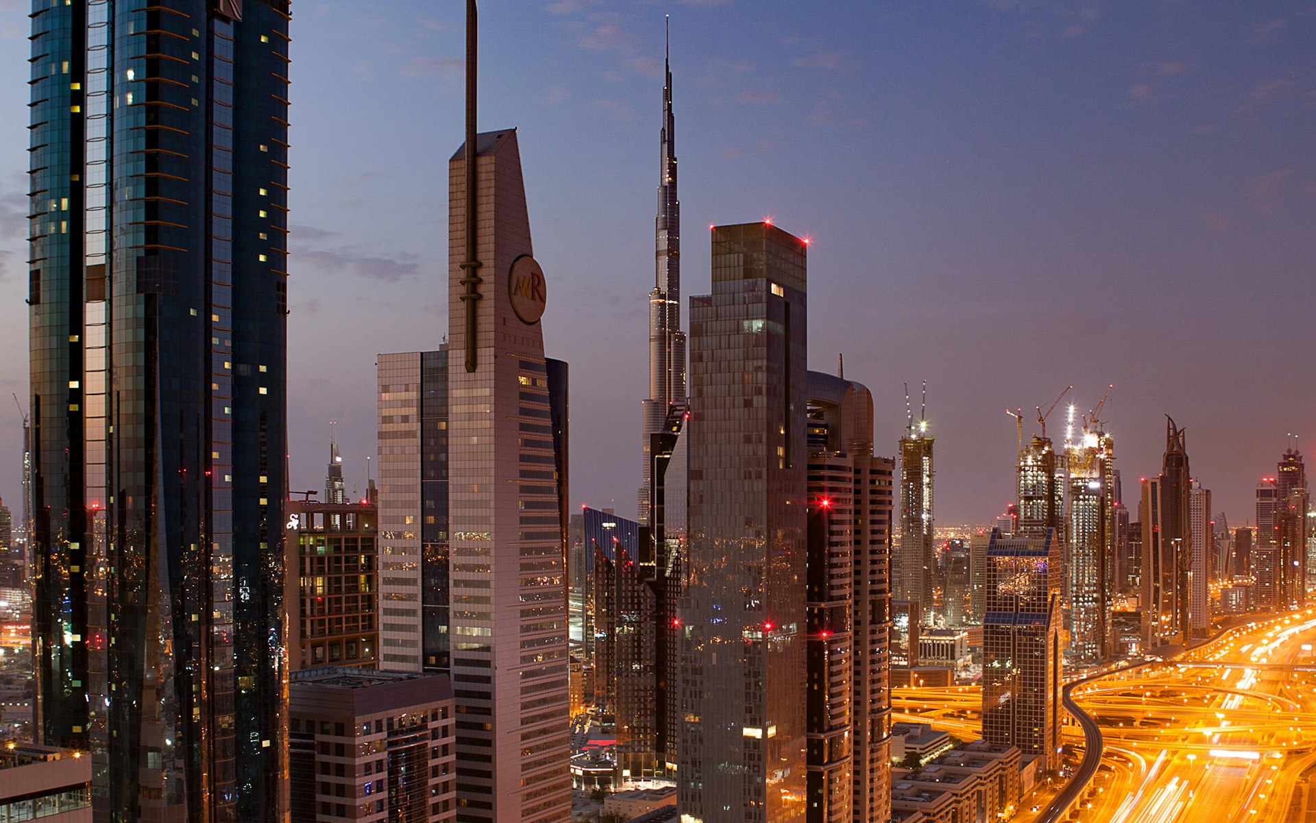 Dubai Marina towers reflected in the water at night