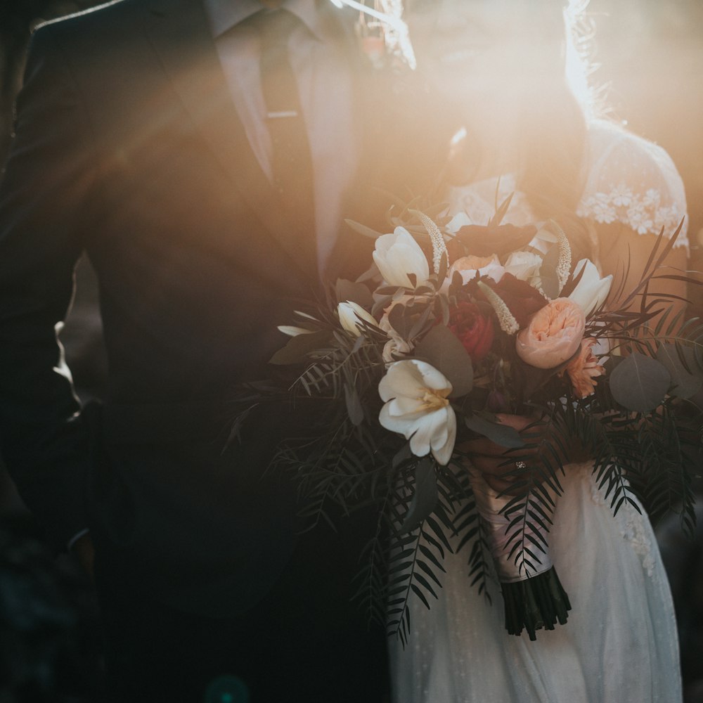 A bride holding a bouquet in soft, low light